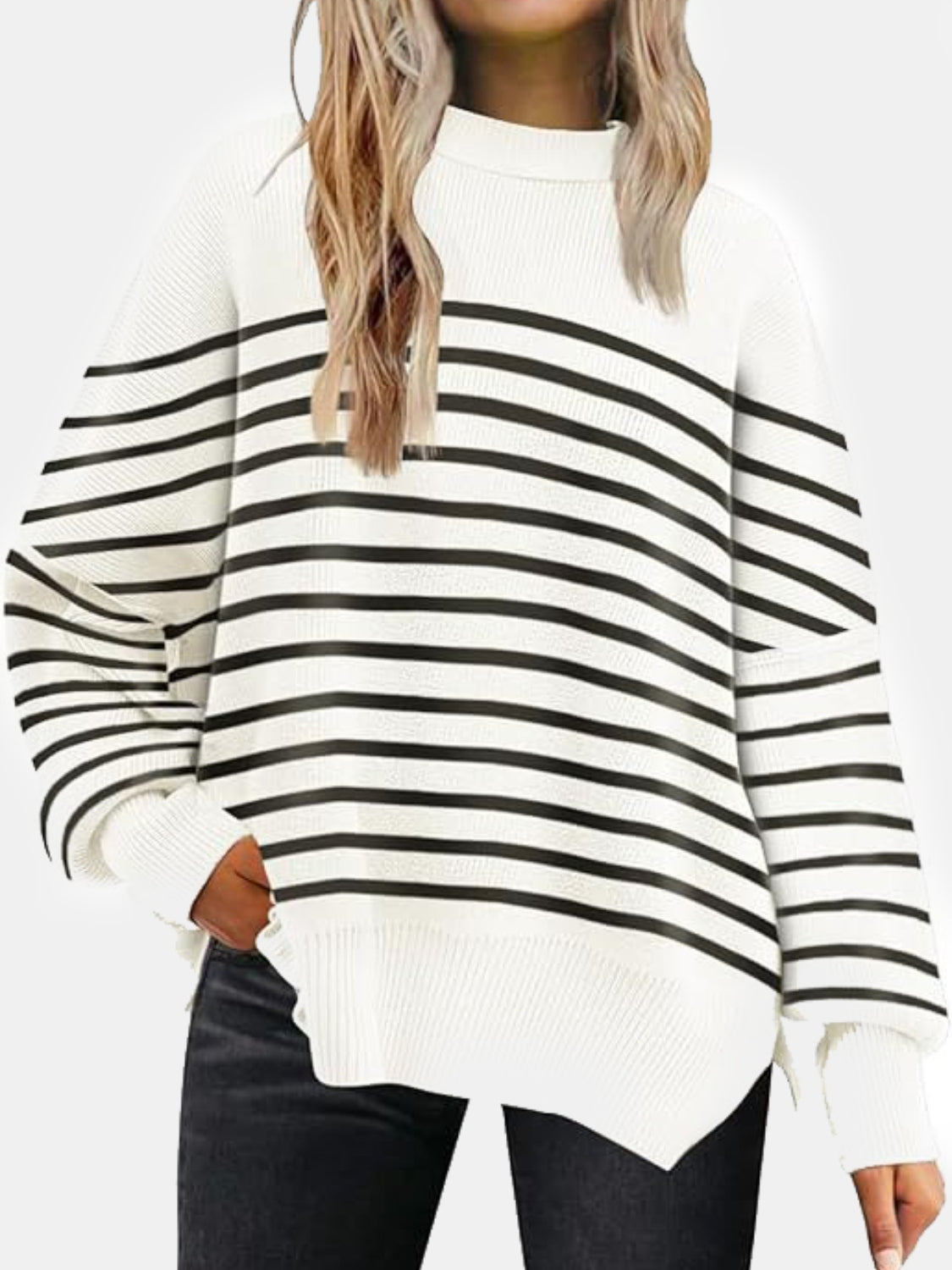 White and black striped knit sweater with slouchy sleeves and ribbed details.