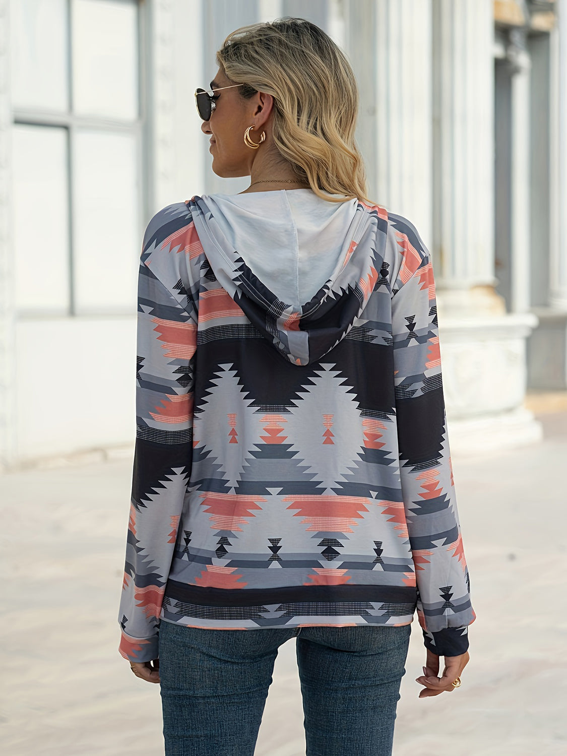 Gray Aztec print zip-up hooded jacket with long sleeves.