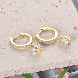 Gold pavé hoop and oval moissanite drop earrings with clear stones.