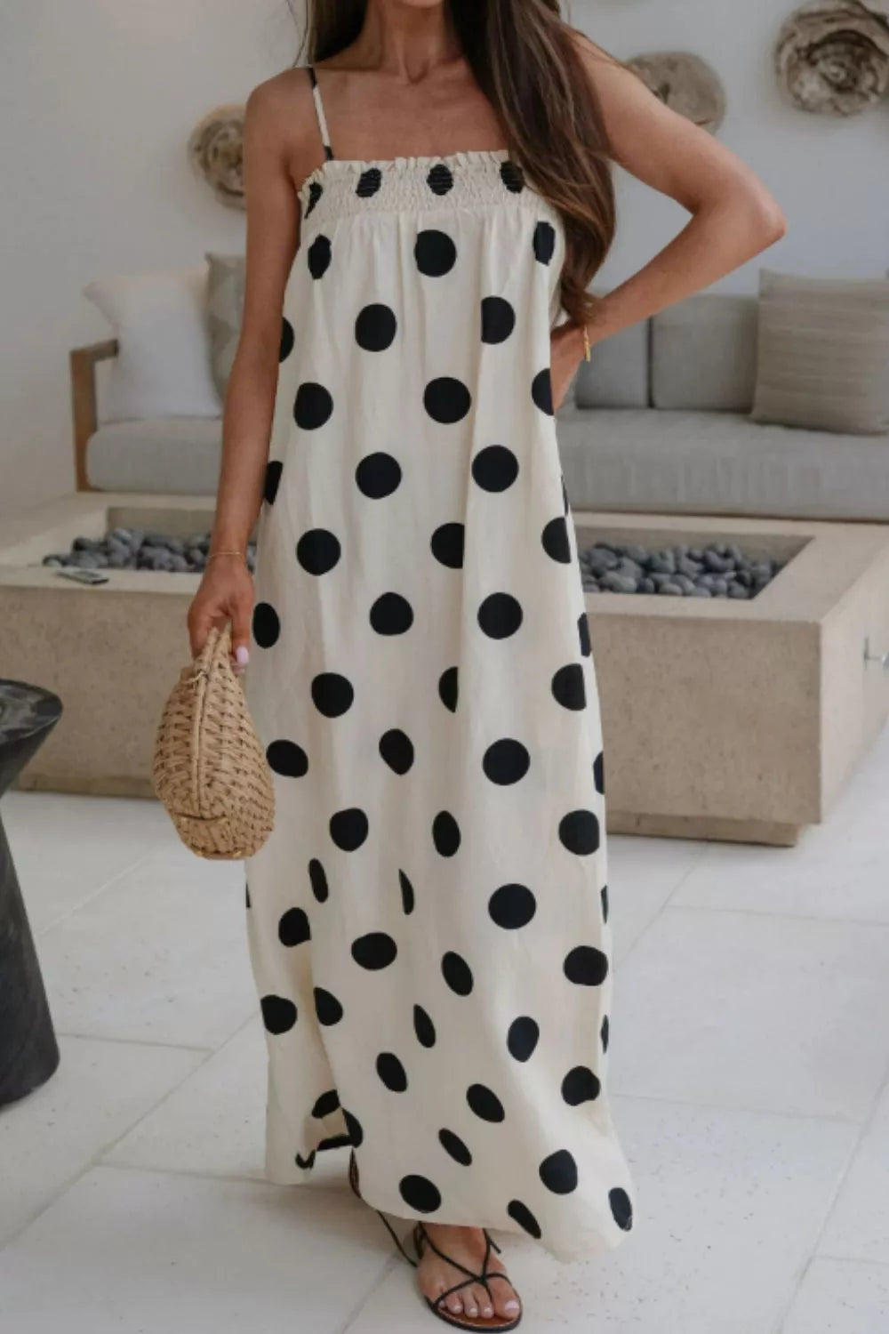 Cream polka dot maxi dress with smocked bodice and spaghetti straps.