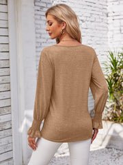 Camel blouson sleeve top with smocked cuffs and V-neck detail.