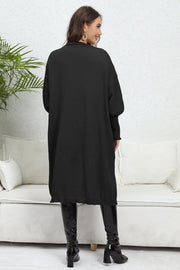 Black oversized pocketed knit cardigan with long sleeves and a relaxed fit.