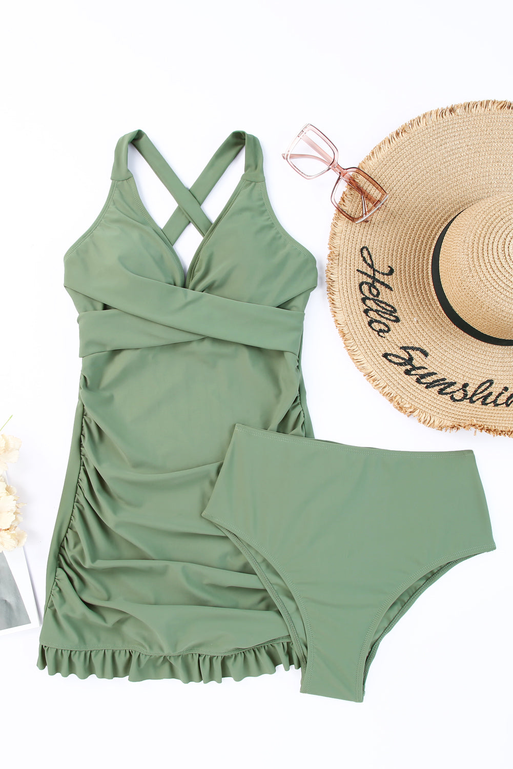 Sage ruched halter swim dress with crisscross bodice and ruffled hem, paired with high-waisted bottoms.
