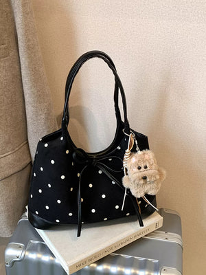 Black polka dot shoulder bag with bow detail and fuzzy charm