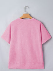 Pink mineral wash cotton t-shirt with short sleeves and a notched neckline.