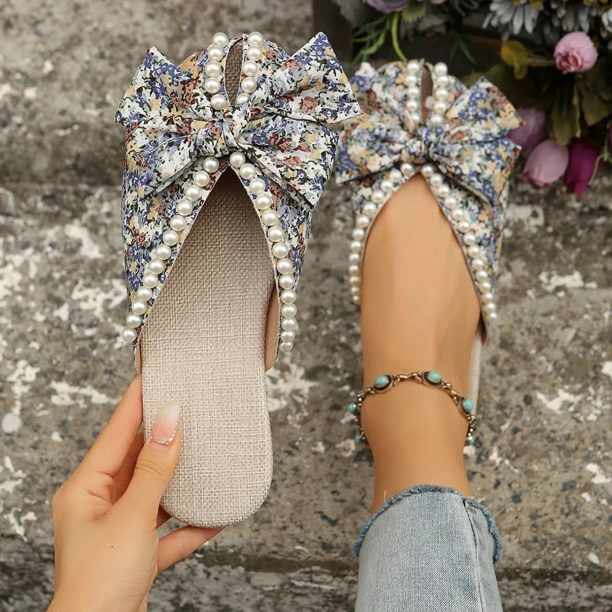 Floral bow pearl embellished slides with a linen sole.