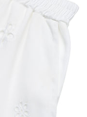 White embroidered lace trim pocketed shorts with elastic waistband.