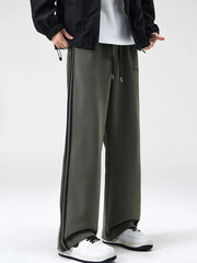 Gray green cotton sweatpants with black side stripes and drawstring waist.