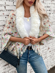 Textured plaid acrylic poncho with white faux fur collar and fringe detail.