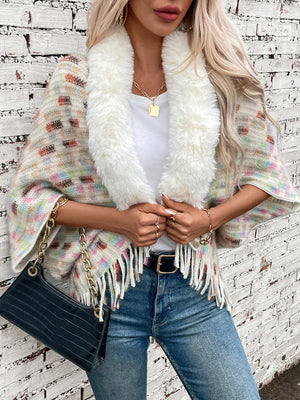 Textured plaid acrylic poncho with white faux fur collar and fringe detail.