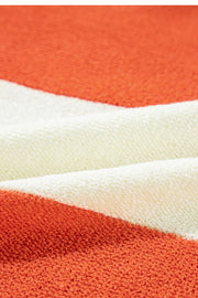Orange and cream striped acrylic knit sweater with a V-neck.