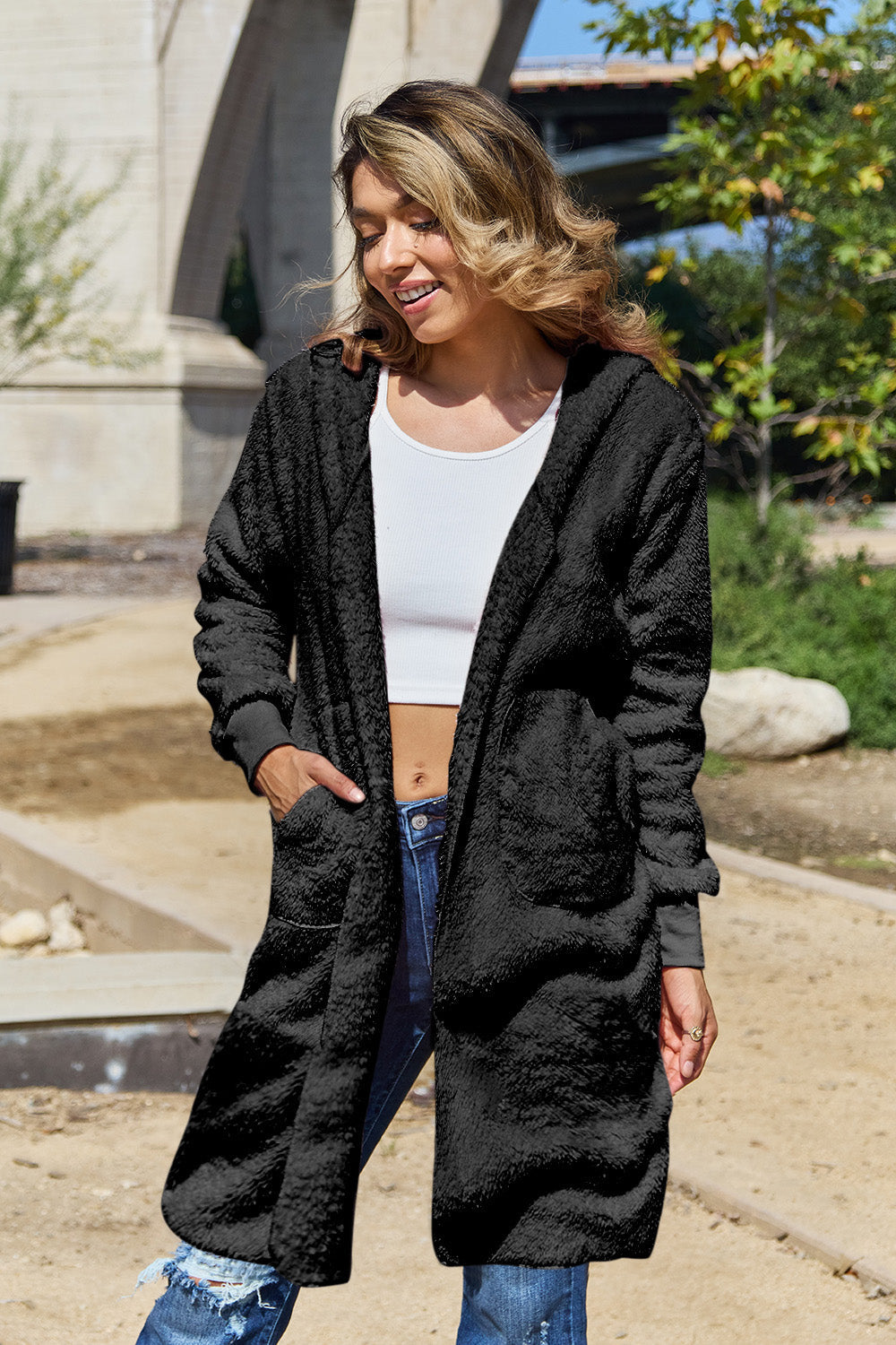 Black plush hooded duster with thumbhole cuffs and pockets.