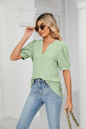 Sage green perforated puff sleeve blouse with V-neck and keyhole detail.