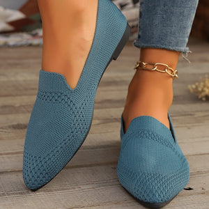 Blue knit pointed-toe flats with a low heel and subtle textured pattern.