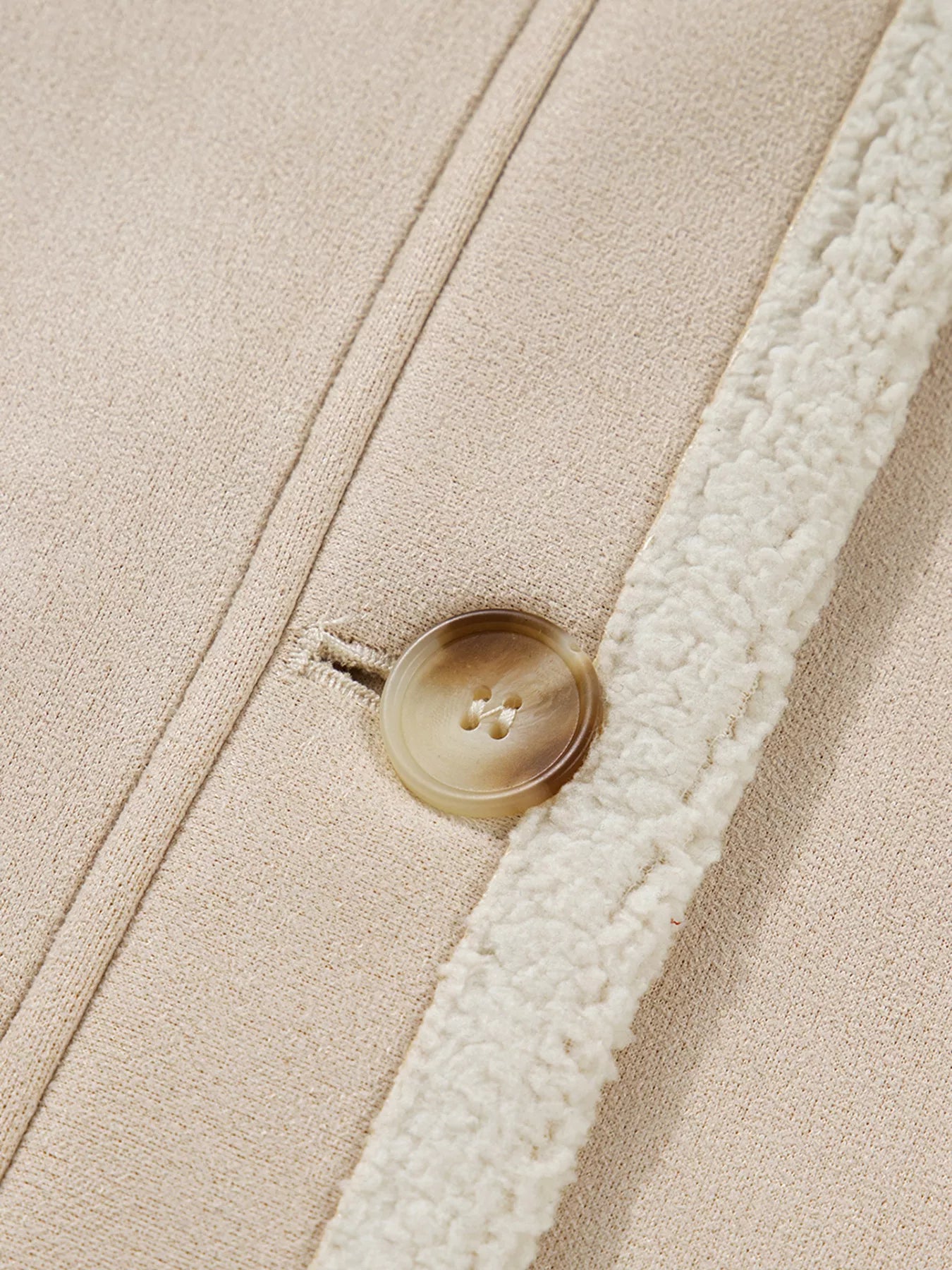 Lined western jacket in eggshell with a button closure and sherpa trim detail.