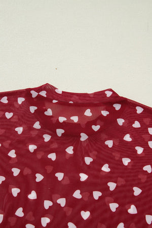 Deep red sheer t-shirt with white heart print and mock neck detail.