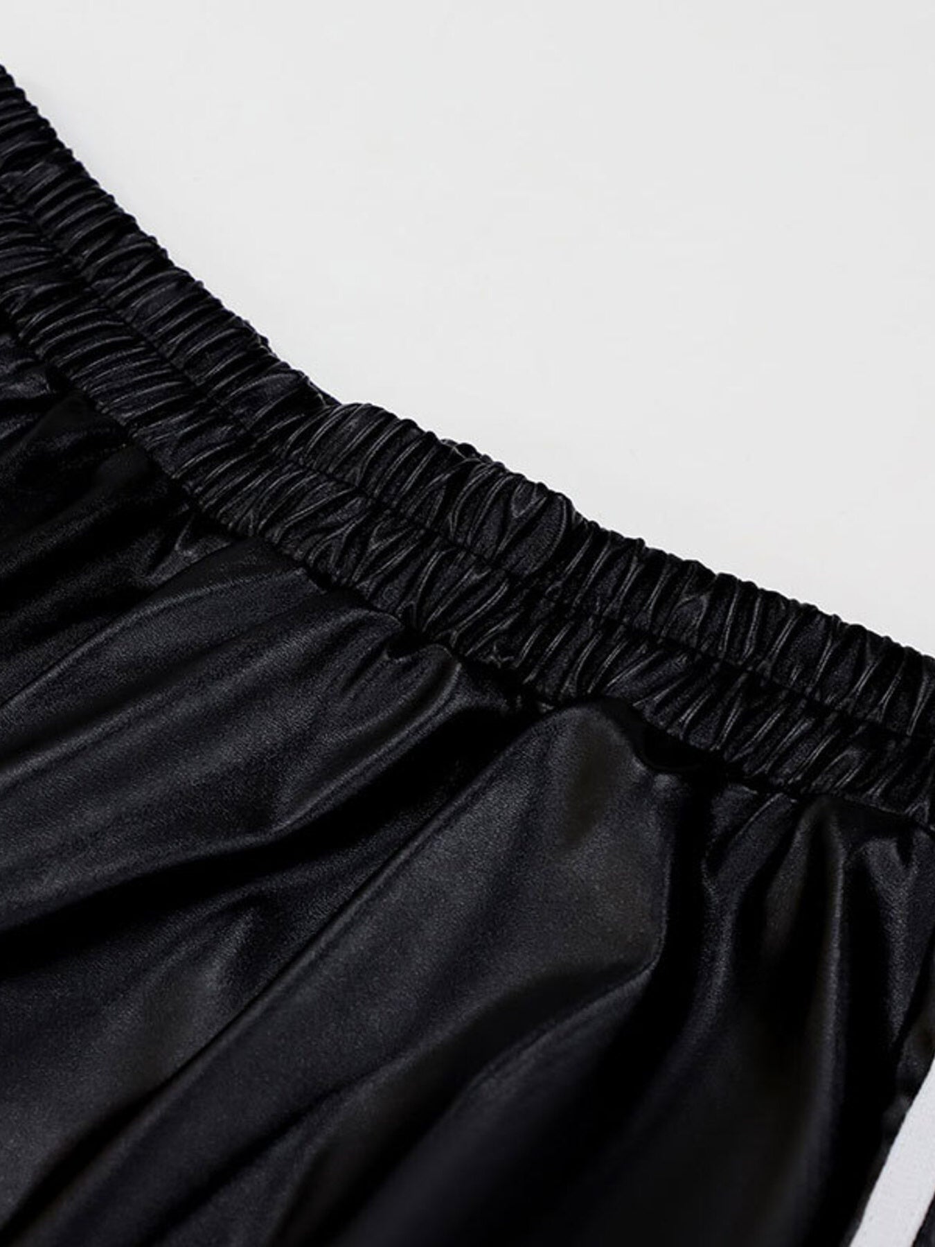 Black faux leather wide leg track pants with elastic waistband detail