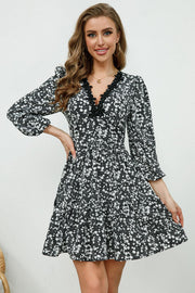 Black floral print mini dress with lace trim V-neck and puff sleeves