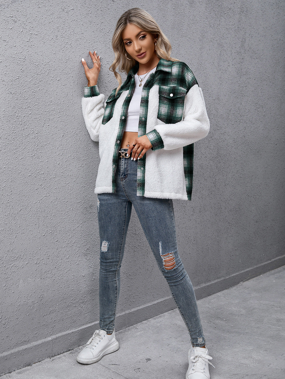 Green plaid shearling hybrid shacket with collared neck and button front, styled with jeans.