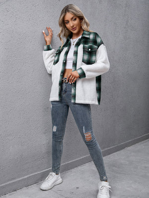 Green plaid shearling hybrid shacket with collared neck and button front, styled with jeans.