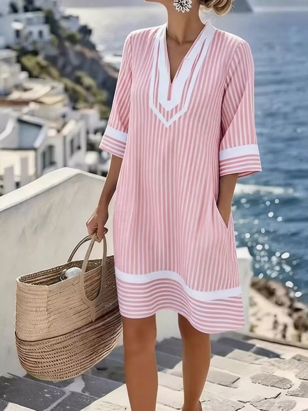 Pink striped V-neck dress with white trim and pockets, 3/4 sleeves.