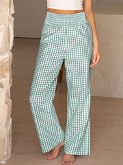 Smocked high-waist wide-leg pants in green gingham with a smocked waistband.