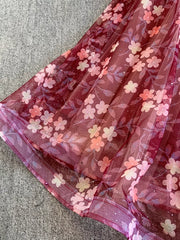 Crimson tulle maxi dress with a floral print and subtle glitter detail.