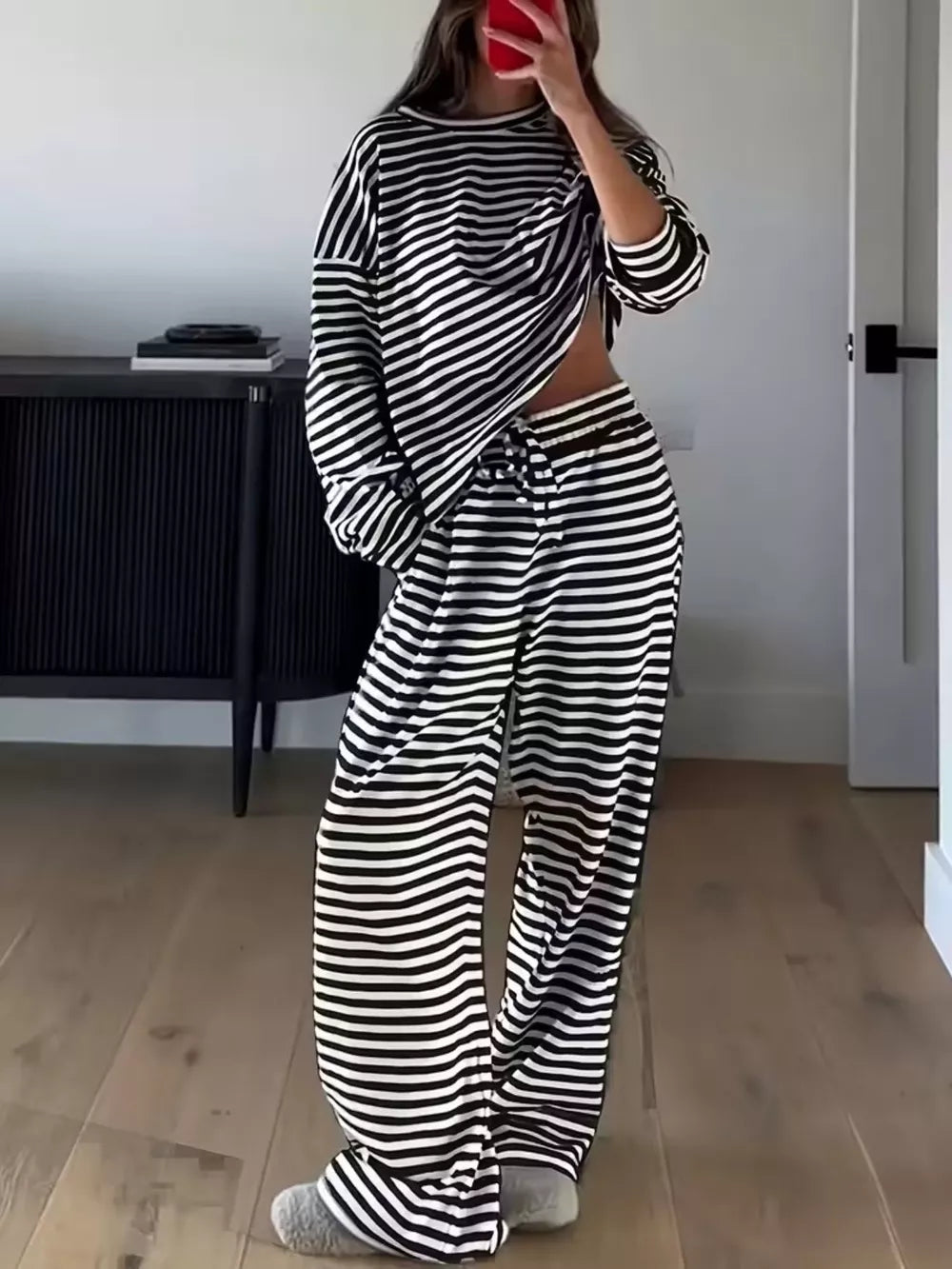 Black and white striped pajama set with drawstring pants and long sleeve top.