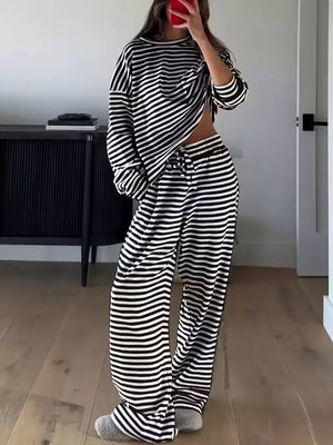 Black and white striped pajama set with drawstring pants and long sleeve top.