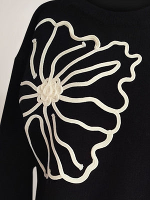 Black long sleeve sweater with white floral embroidery detail