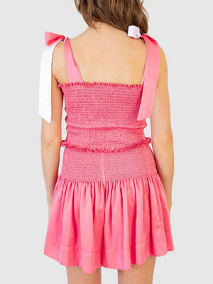 Smocked bodice and skirt set in strawberry pink with tie shoulder straps and ruffled trim.