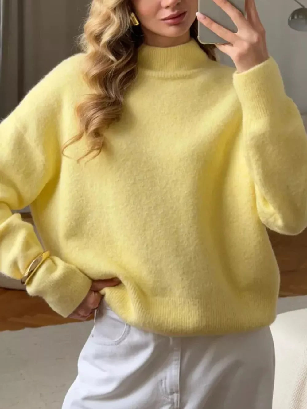 Relaxed mock neck knit sweater in pastel yellow acrylic blend with long sleeves.