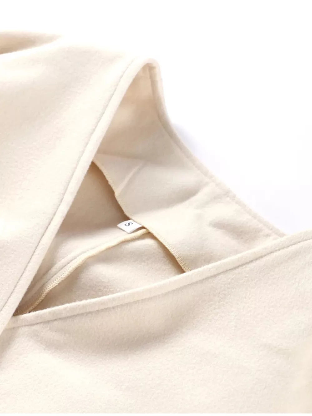 Beige wool blend trench coat with surplice neckline and tie waist detail.