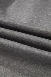 Dark gray knit fabric detail of a chic half-zip polo and wide-leg set.