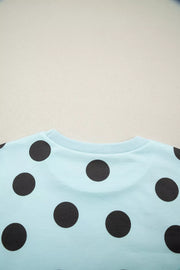 Light blue crew neck top with black polka dots
