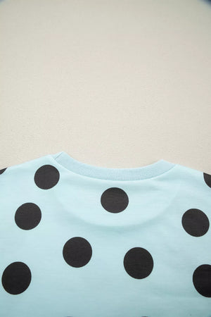 Light blue crew neck top with black polka dots
