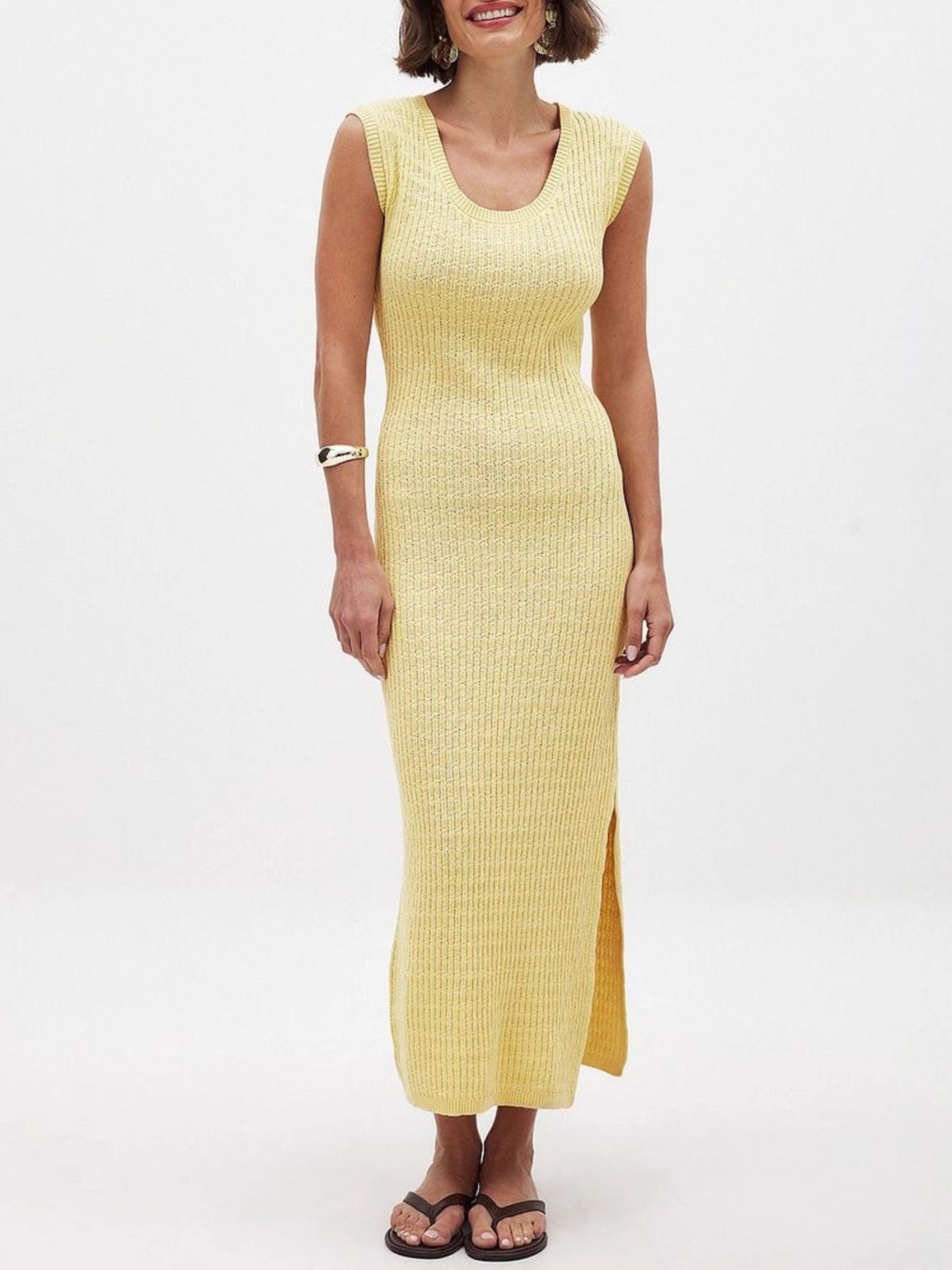 Yellow knit midi dress with scoop neck, sleeveless, and side slit.
