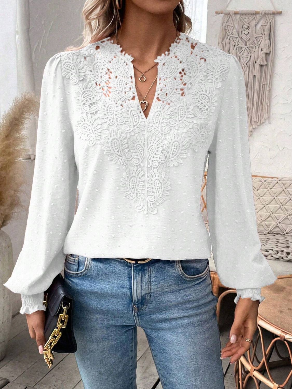 White embroidered yoke blouse with puff sleeves and textured fabric.