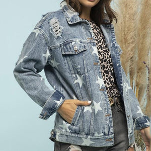 Light wash denim trucker jacket with white stars and distressed details.