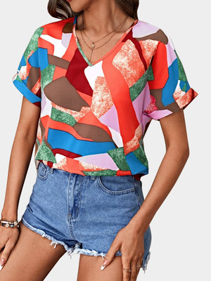 Geometric print V-neck blouse with short sleeves in multicolor.