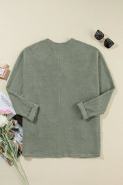 Sage waffle knit open-front duster cardigan with cuffed sleeves.