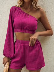 Textured one-shoulder crop top and cuffed shorts set in magenta