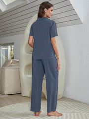 Blue silk-blend pajama set with short sleeve shirt and wide leg pants.