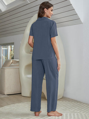 Blue silk-blend pajama set with short sleeve shirt and wide leg pants.