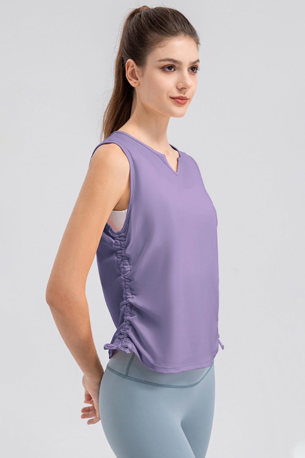 Lavender active tank top with notched neckline and ruched sides.