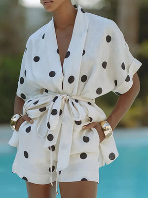 White polka dot tie-waist two-piece set with cuffed sleeves and shorts.