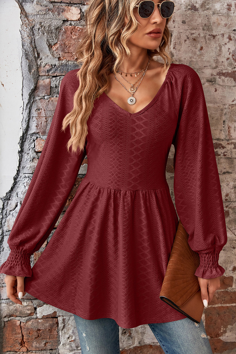 Burgundy textured empire waist blouse with shirred sleeves and v-neck