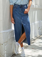 Denim midi skirt in dark wash with a high slit and raw hem.