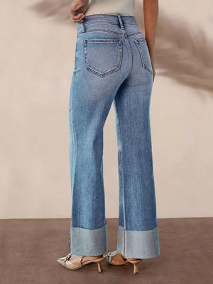 Distressed high-waisted flare maternity jeans with raw hem cuffs in light wash denim.