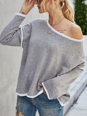Off-shoulder knit pullover sweater in dark gray with white trim and long sleeves.